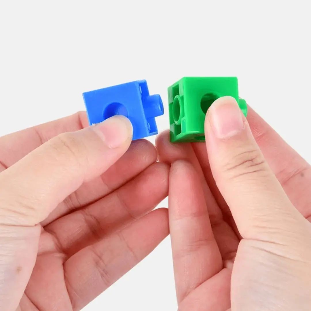 Enfant manipulant les pièces du jeu éducatif Montessori Cube Magic pour développer sa motricité fine et sa coordination